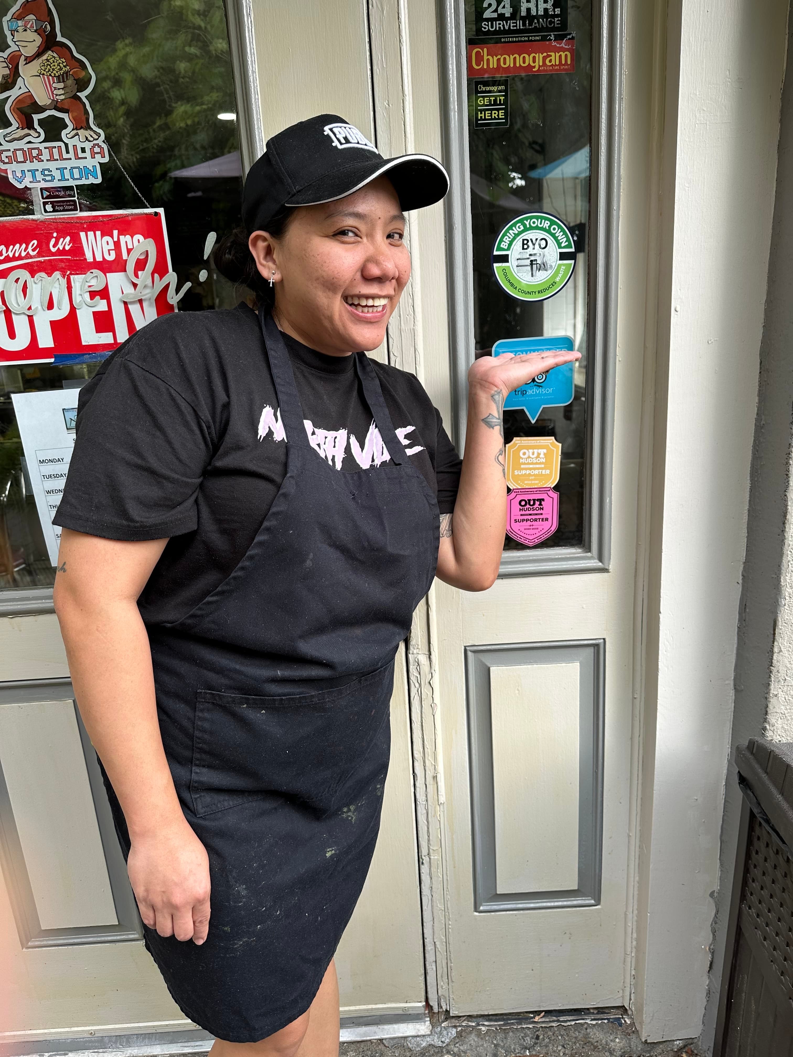 Che Che standing in front of Nolita with their BYO sticker